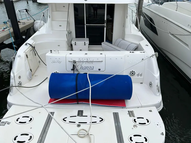 Slide: The Image of 2008 Sea Ray 44 Sedan Bridge yacht docked, featuring spacious deck and seating area. - 37