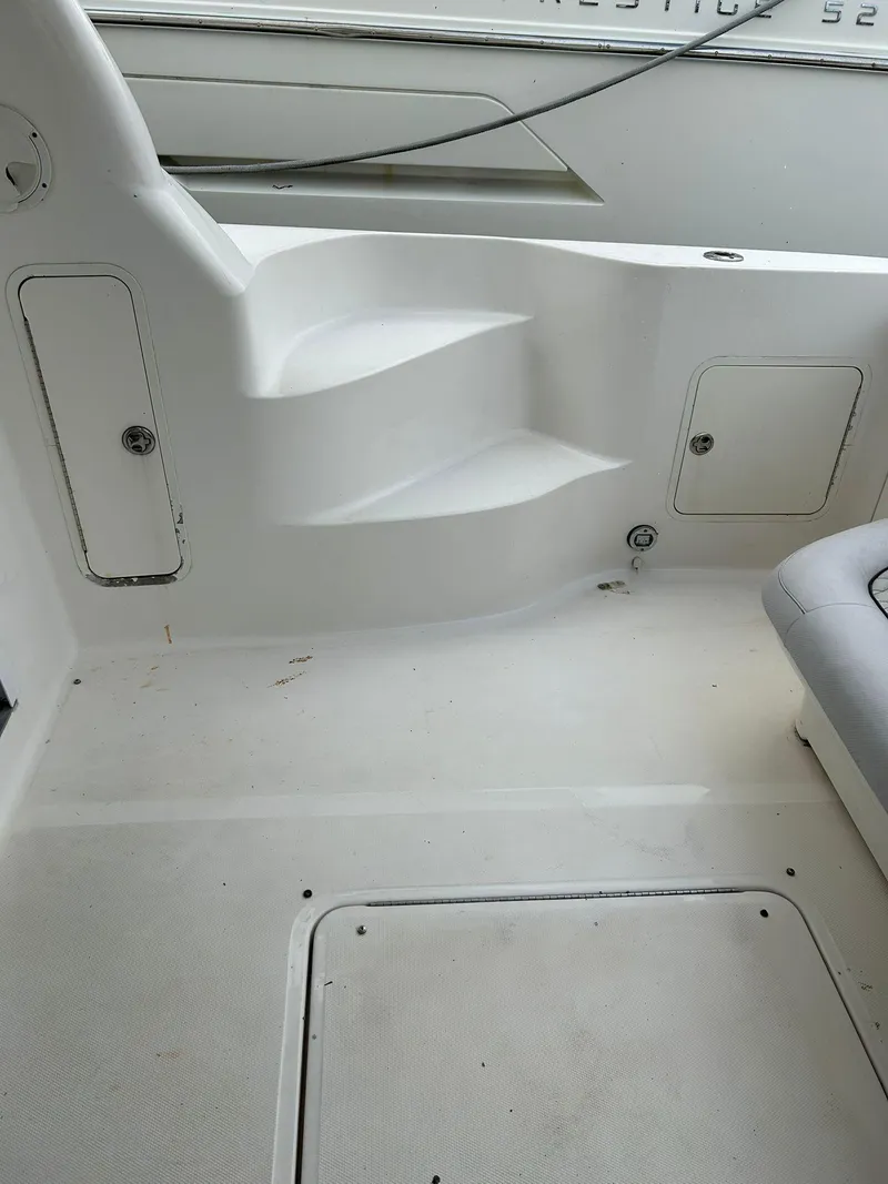 Slide: The Image of 2008 Sea Ray 44 Sedan Bridge boat interior with white seating and storage compartments. - 40