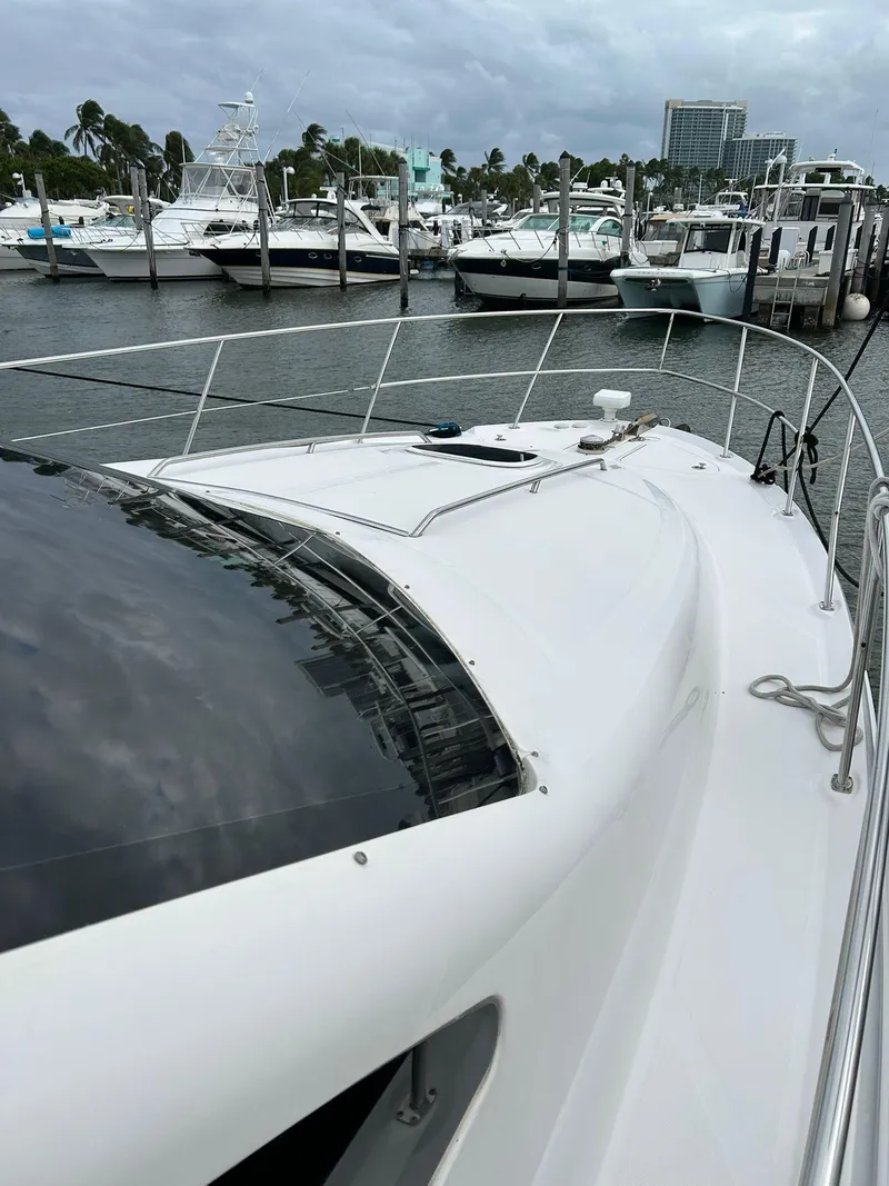 Slide: The Image of 2008 Sea Ray 44 Sedan Bridge yacht docked at marina, overcast sky. - 7