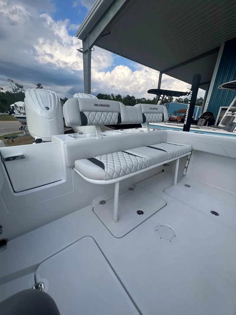 Slide: The Image of 2025 Bluewater 25 T boat interior with white seating and modern design. - 10