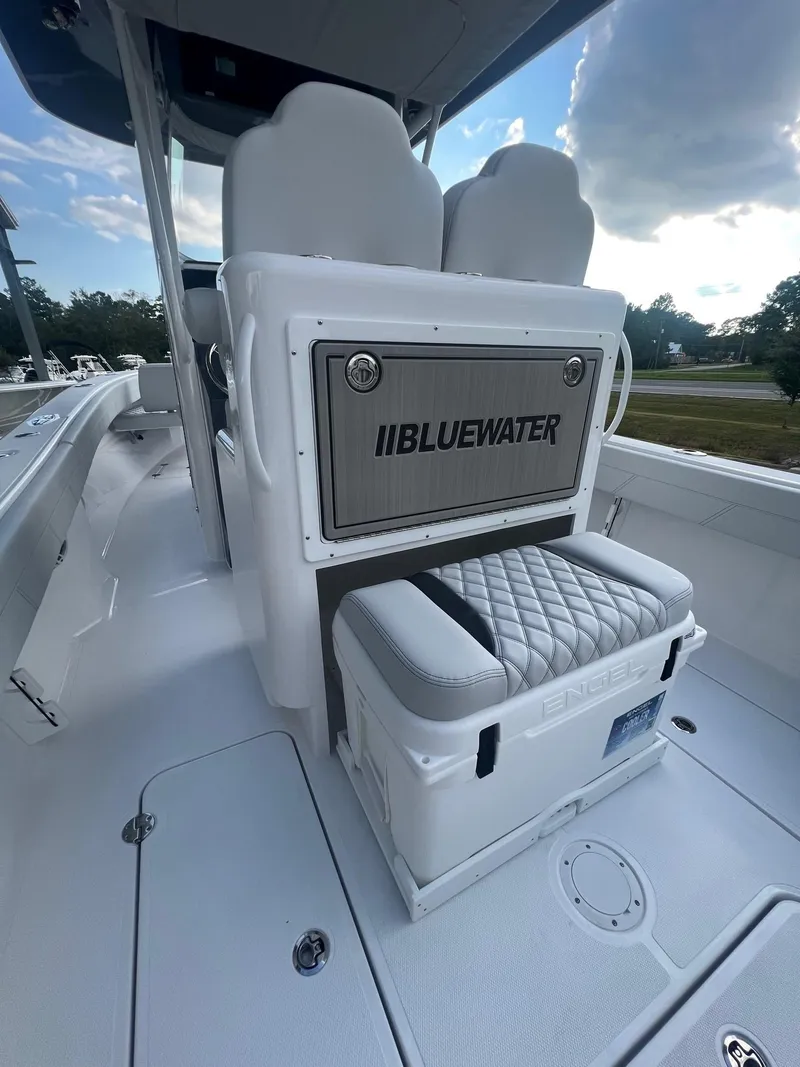 Slide: The Image of 2025 Bluewater 25 T boat interior with cushioned seating and storage. - 8