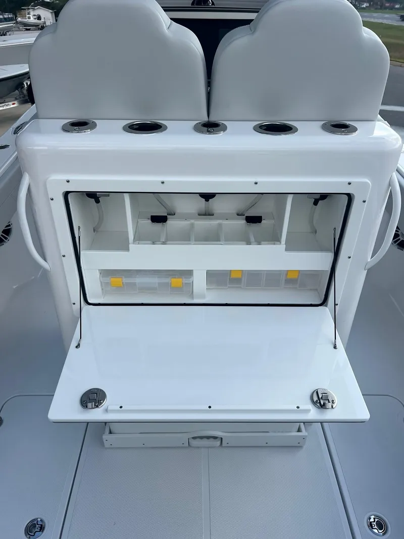 Slide: The Image of 2025 Bluewater 25 T boat with open storage compartment and seating. - 9