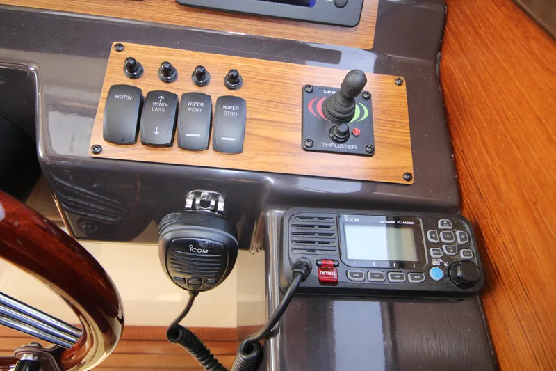 Slide: The Image of Control panel of 2023 Ranger Tugs R-27 Luxury Edition with switches and communication device. - 15