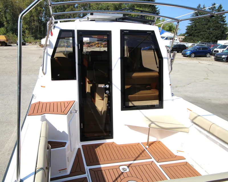 Slide: The Image of 2023 Ranger Tugs R-27 Luxury Edition boat with teak deck and spacious cockpit. - 17