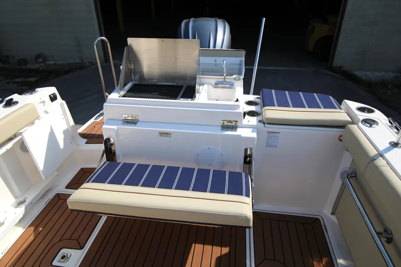 Slide: The Image of 2023 Ranger Tugs R-27 Luxury Edition boat with outdoor seating and grill. - 19