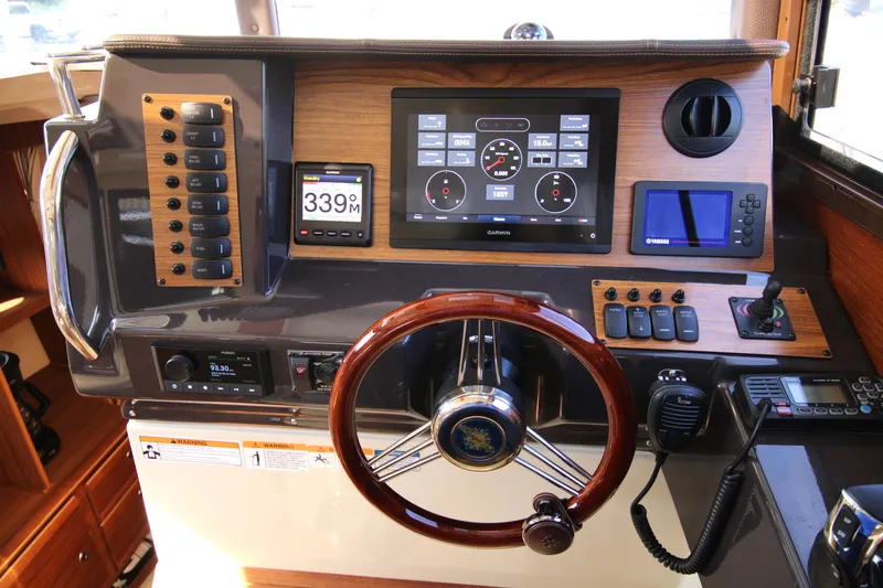 Slide: The Image of 2023 Ranger Tugs R-27 Luxury Edition helm with advanced navigation and control systems. - 2