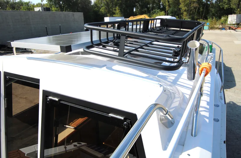 Slide: The Image of 2023 Ranger Tugs R-27 Luxury Edition boat roof with railing and storage rack. - 25