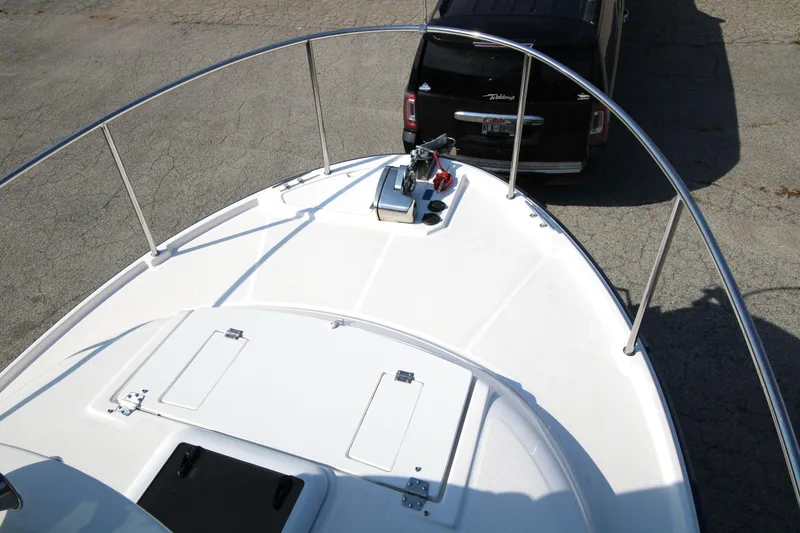 Slide: The Image of 2023 Ranger Tugs R-27 Luxury Edition boat deck with railing and hatch. - 28