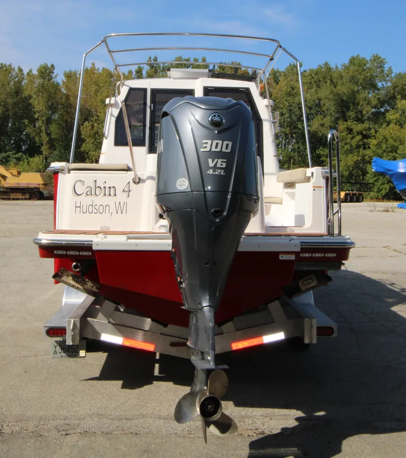Slide: The Image of 2023 Ranger Tugs R-27 Luxury Edition boat with 300 V6 engine, rear view. - 4