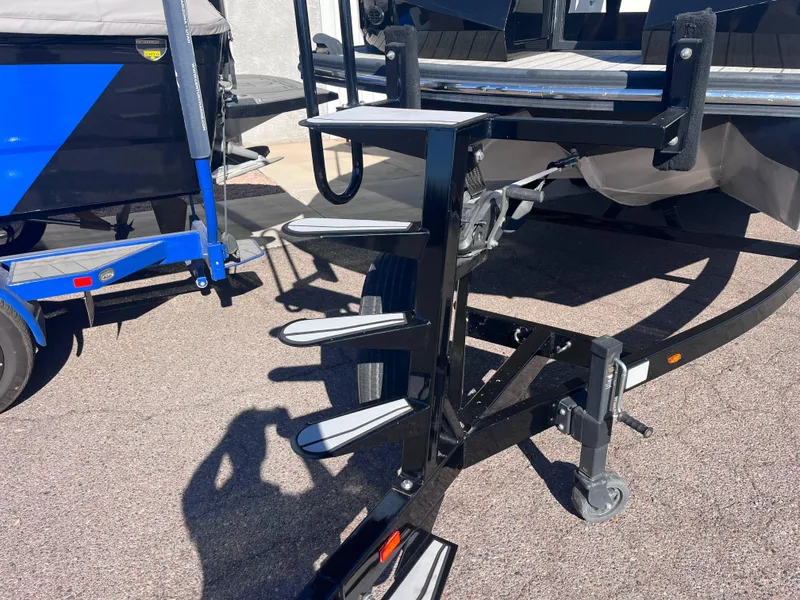 Slide: The Image of Montara Surf Boss 2020 boat trailer with steps, parked on pavement. - 5