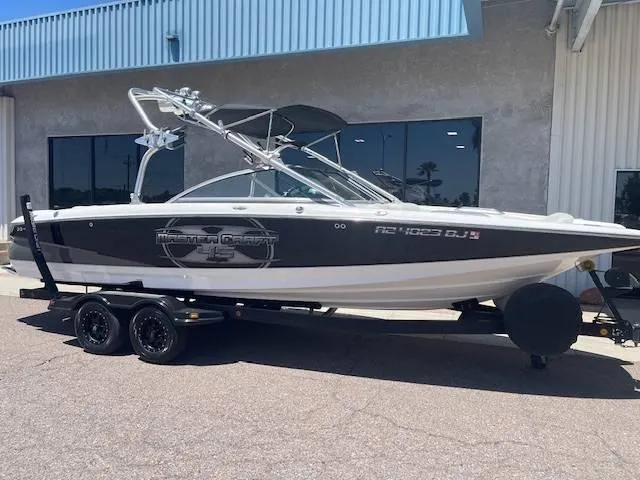 Slide: The Image of 2006 MasterCraft X45 boat on trailer outside a building. - 13