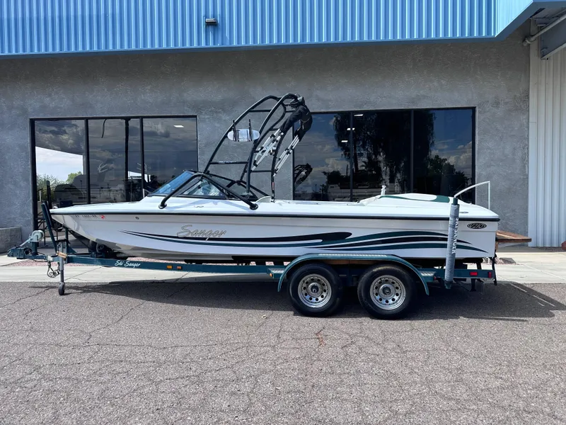 Slide: The Image of 2003 Sanger Z210 boat on trailer outside a building. - 1