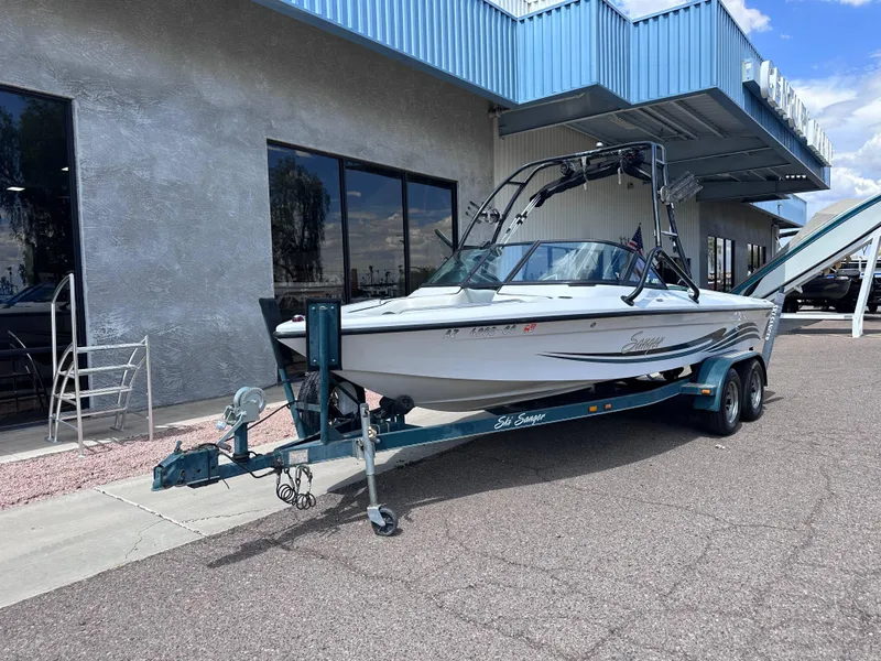 Slide: The Image of 2003 Sanger Z210 boat on trailer outside a building. - 2