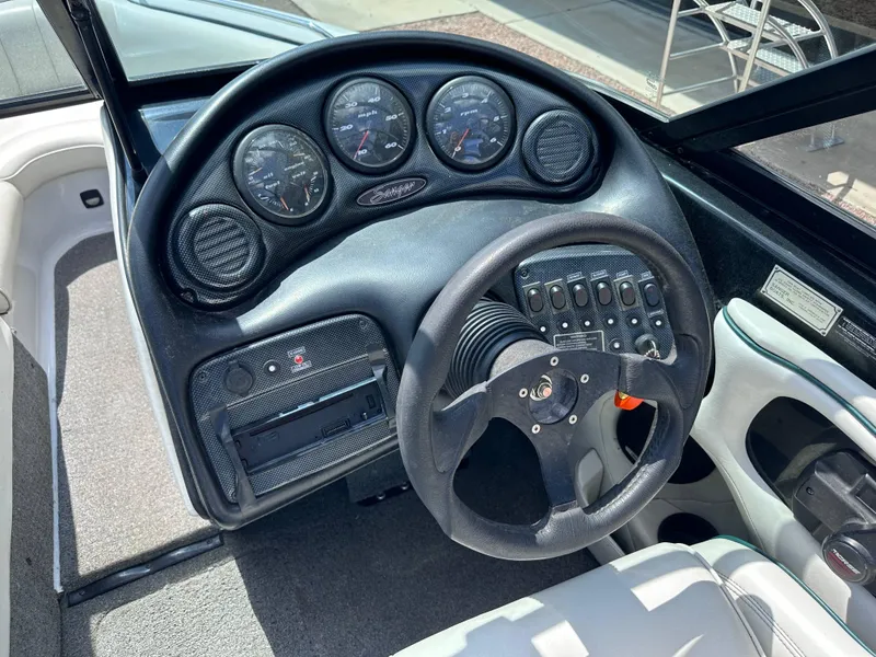 Slide: The Image of 2003 Sanger Z210 boat dashboard with steering wheel and gauges. - 6