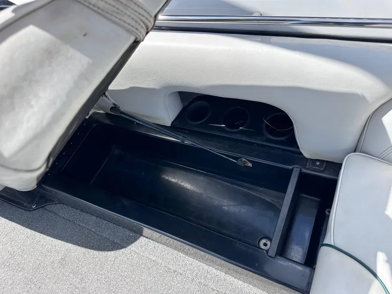 Slide: The Image of Open storage compartment in 2003 Sanger Z210 boat interior. - 7