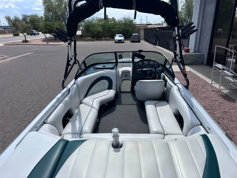 Slide: The Image of Interior of a 2003 Sanger Z210 boat with white seating and steering console. - 8