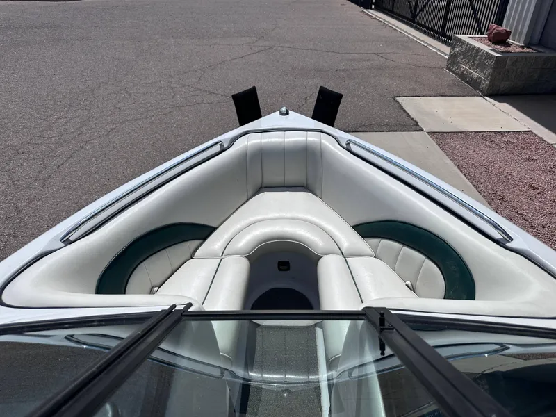 Slide: The Image of 2003 Sanger Z210 boat interior with white and green seating. - 9
