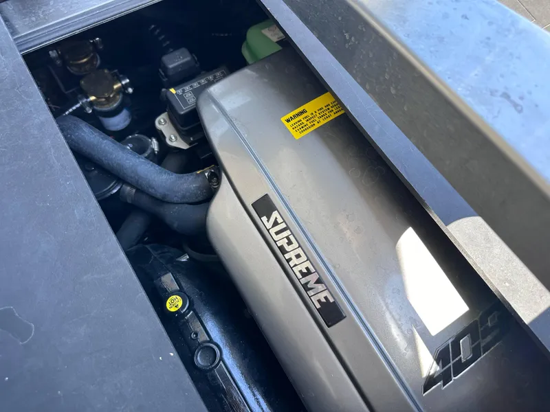 Slide: The Image of Close-up of 2022 Supreme S220 engine compartment with visible components and branding. - 11