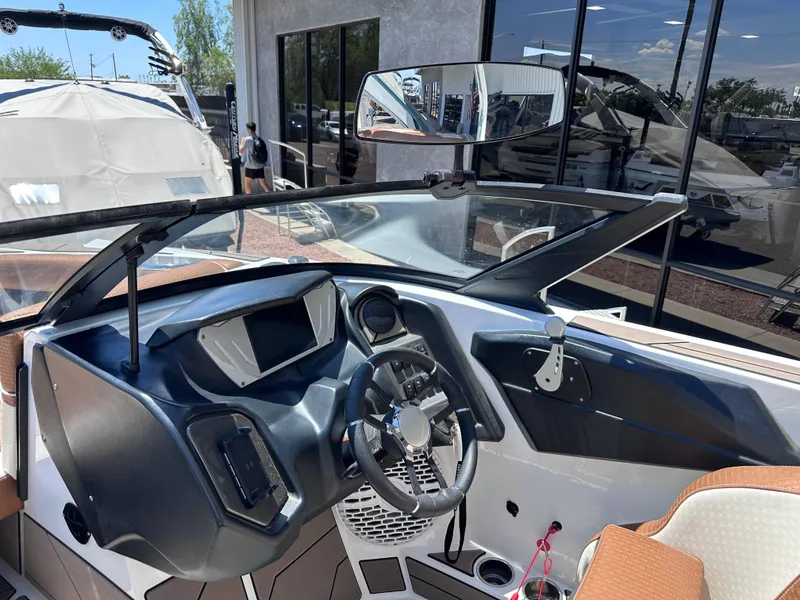 Slide: The Image of 2022 Supreme S220 boat dashboard with steering wheel and modern controls. - 6