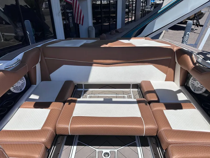 Slide: The Image of 2022 Supreme S220 boat interior with brown and white seating, modern design. - 8