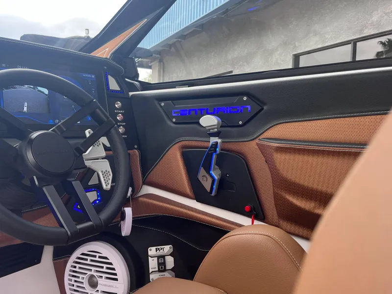 Slide: The Image of Interior of 2025 Centurion Ri245 boat with modern dashboard and steering wheel. - 13