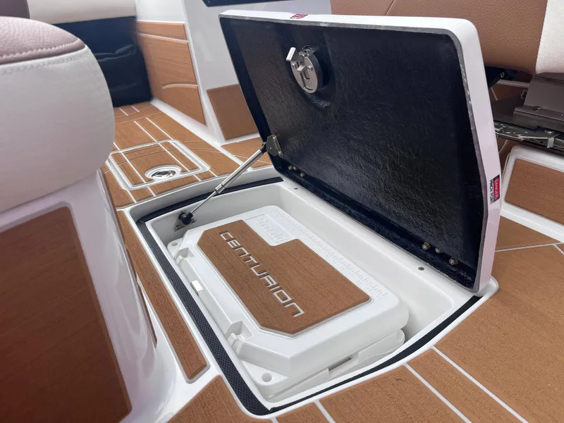 Slide: The Image of Centurion Ri245 2025 boat storage compartment with open hatch and branded interior. - 14