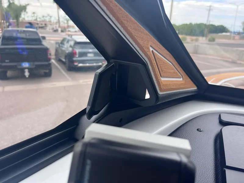 Slide: The Image of Interior view of 2025 Centurion Ri245 boat dashboard with wood accents. - 15