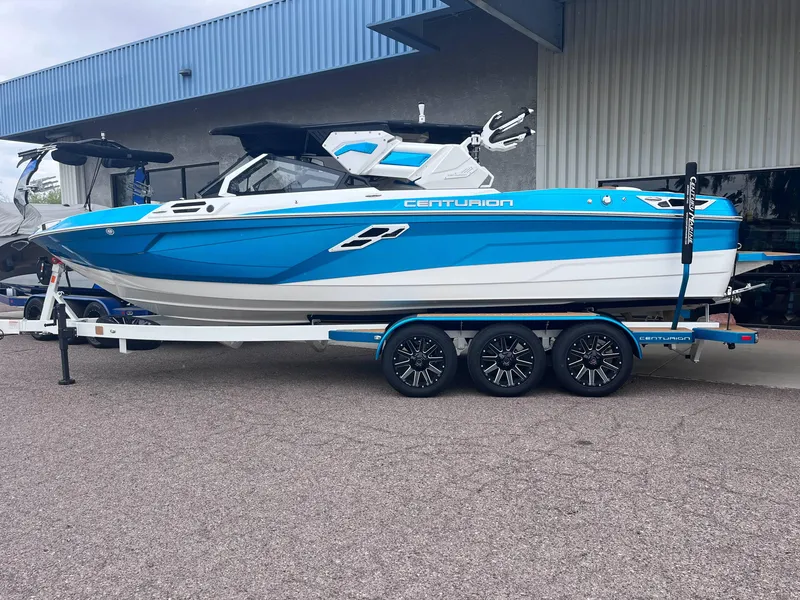 Slide: The Image of 2025 Centurion Ri245 boat in blue and white on a trailer. - 3