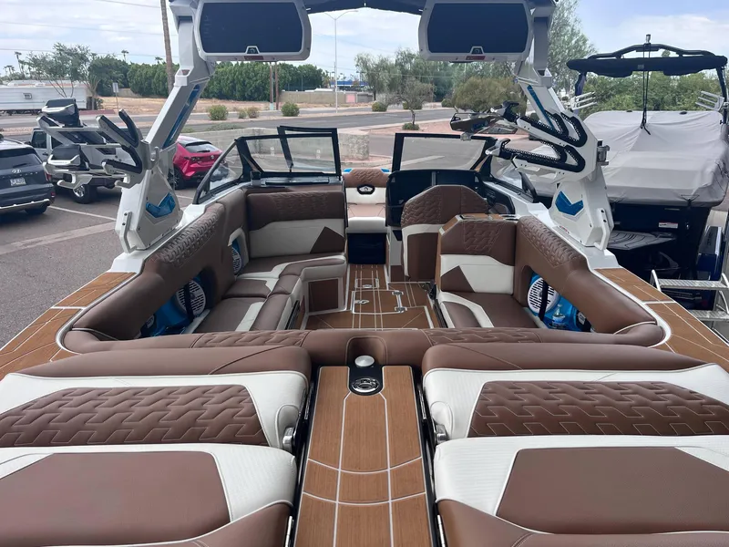 Slide: The Image of 2025 Centurion Ri245 boat interior with luxurious brown and white seating. - 5