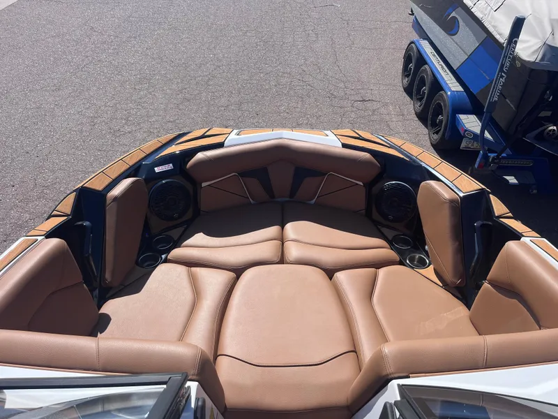 Slide: The Image of 2025 Centurion Fe23 boat interior with tan leather seating and cup holders. - 10