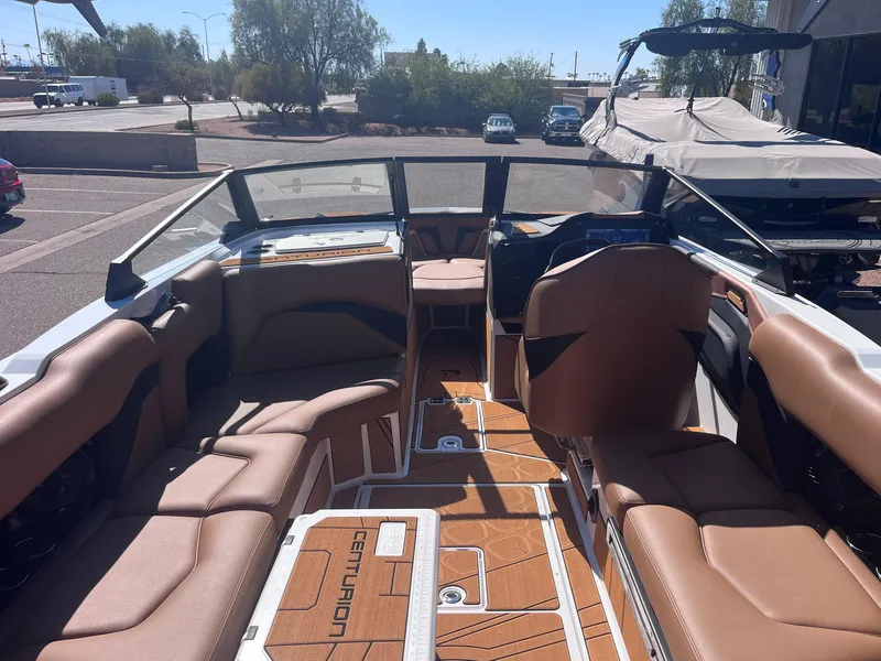 Slide: The Image of Interior of 2025 Centurion Fe23 boat with tan seating and modern dashboard. - 5