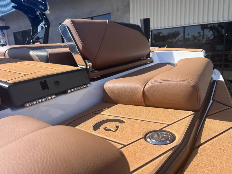 Slide: The Image of 2025 Centurion Fe23 boat interior with brown leather seating and sleek design. - 9