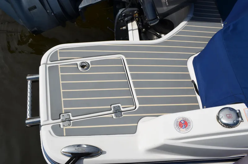 Slide: The Image of 2016 Chaparral 250 Suncoast boat deck with swim platform and ladder. - 12