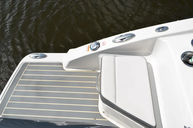 Slide: The Image of 2016 Chaparral 250 Suncoast boat deck with seating, near water. - 15