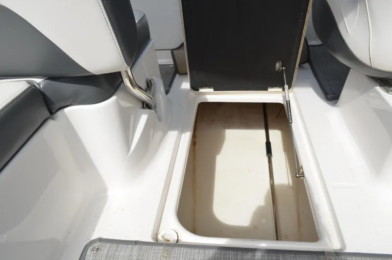 Slide: The Image of Open storage compartment in 2016 Chaparral 250 Suncoast boat interior. - 17