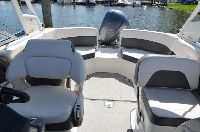 Slide: The Image of 2016 Chaparral 250 Suncoast boat interior with seating and outboard motor. - 19