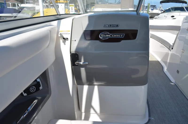 Slide: The Image of Interior view of 2016 Chaparral 250 Suncoast boat, featuring deluxe Suncoast branding. - 24