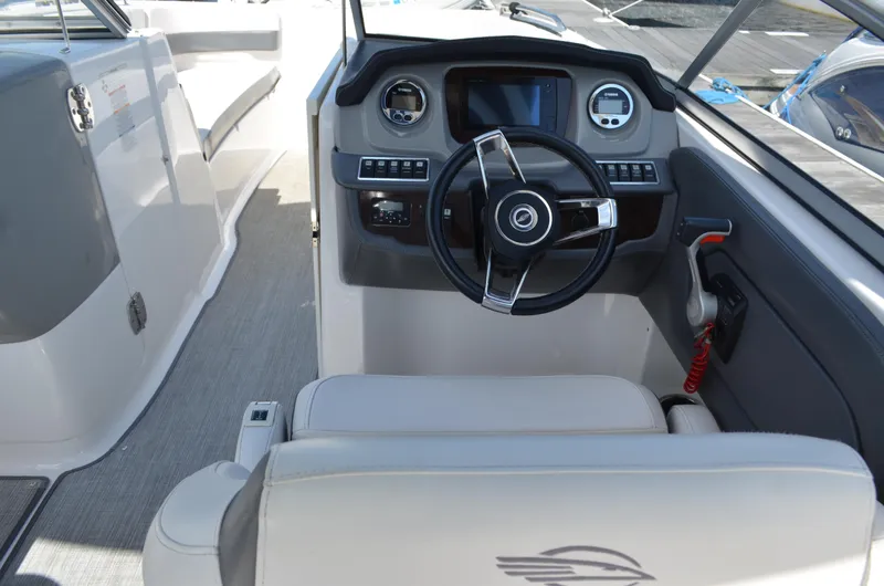 Slide: The Image of Interior view of 2016 Chaparral 250 Suncoast boat cockpit with steering wheel and controls. - 25