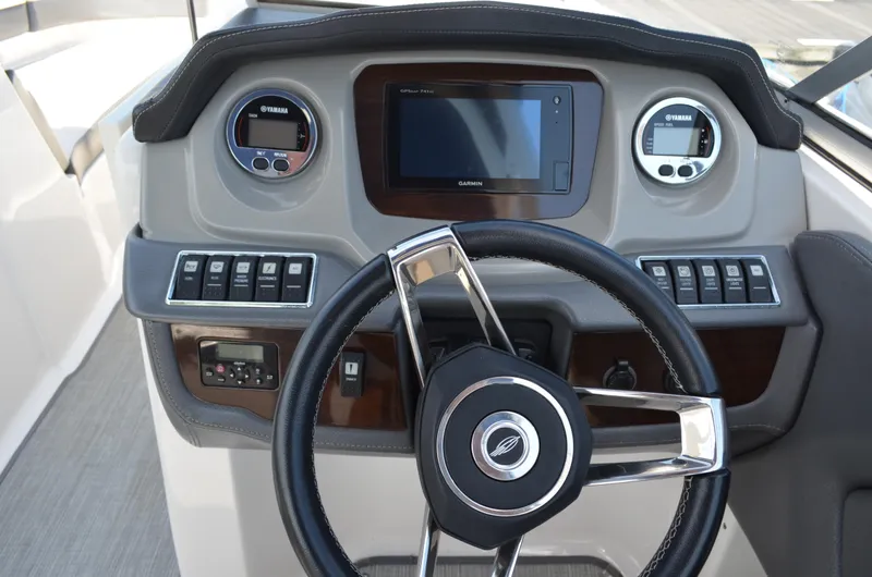 Slide: The Image of Dashboard of 2016 Chaparral 250 Suncoast boat with steering wheel and control panel. - 26