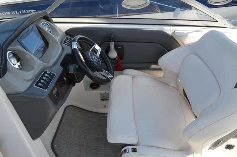 Slide: The Image of Interior cockpit of 2016 Chaparral 250 Suncoast boat with steering wheel and controls. - 27