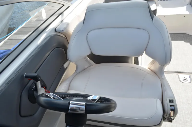 Slide: The Image of Captain's seat and steering wheel of 2016 Chaparral 250 Suncoast boat. - 28