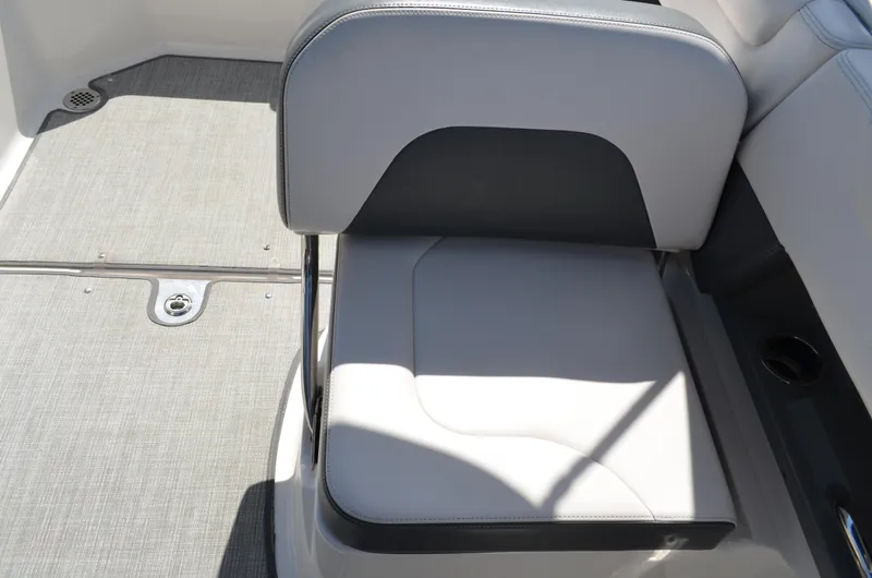 Slide: The Image of 2016 Chaparral 250 Suncoast boat seat with gray upholstery and deck flooring. - 29