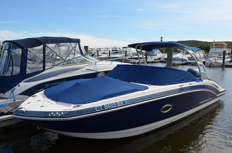 Slide: The Image of 2016 Chaparral 250 Suncoast boat docked at marina, covered with blue tarp. - 3