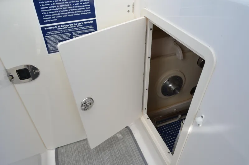 Slide: The Image of Open storage compartment on 2016 Chaparral 250 Suncoast boat. - 30