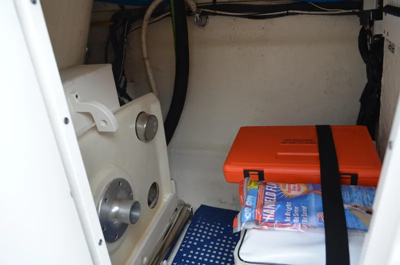 Slide: The Image of Interior storage compartment of 2016 Chaparral 250 Suncoast boat with safety equipment. - 31