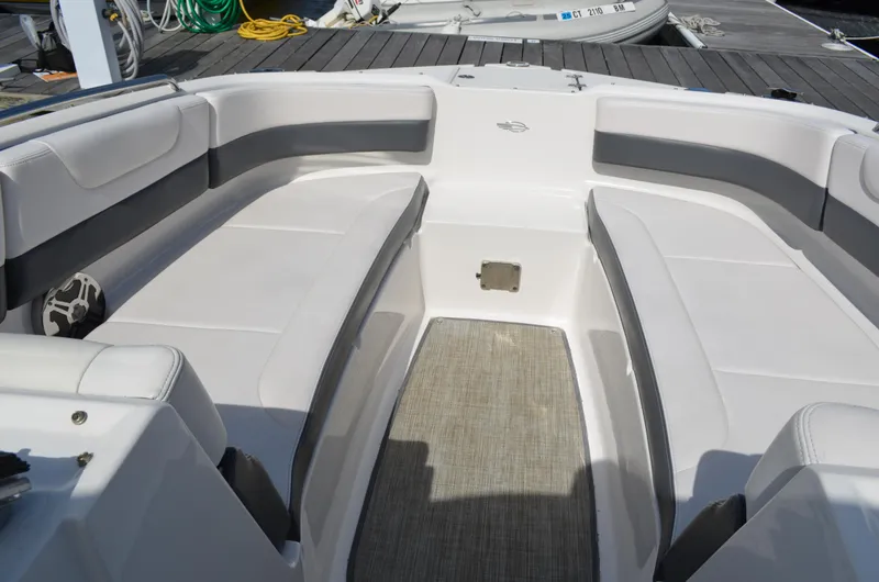 Slide: The Image of 2016 Chaparral 250 Suncoast boat interior with white seating and gray accents. - 34