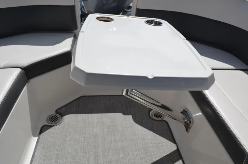 Slide: The Image of 2016 Chaparral 250 Suncoast boat interior with table and seating area. - 35