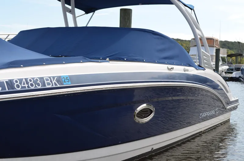 Slide: The Image of 2016 Chaparral 250 Suncoast boat with blue cover docked in marina. - 4