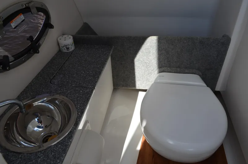 Slide: The Image of 2016 Chaparral 250 Suncoast boat bathroom with sink and toilet. - 43