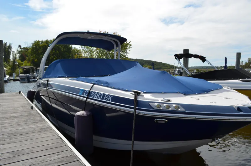 Slide: The Image of 2016 Chaparral 250 Suncoast boat docked with blue cover, sunny day. - 7